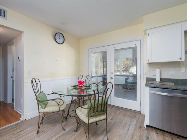 dining room featuring light wood-type flooring and french doors