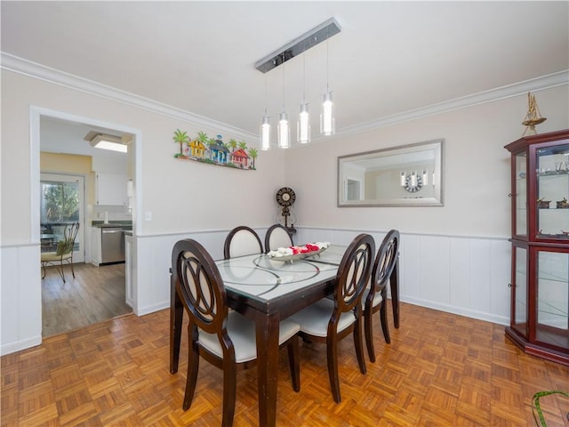 dining space featuring parquet floors and crown molding