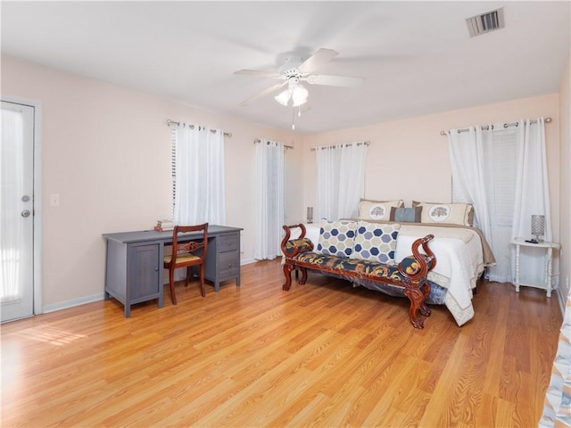 bedroom featuring multiple windows, ceiling fan, and light hardwood / wood-style flooring