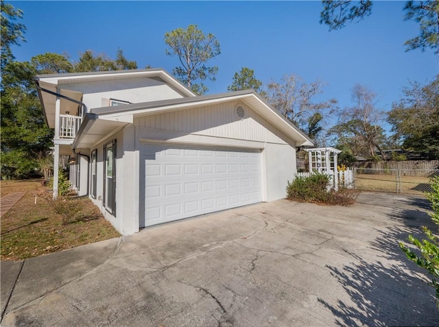 view of home's exterior featuring a balcony and a garage