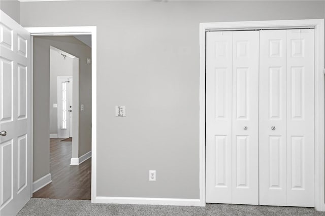 unfurnished bedroom with baseboards and a closet