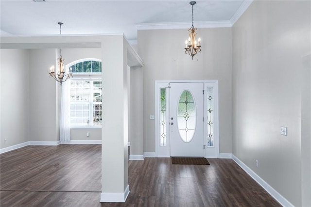 foyer featuring baseboards, dark wood finished floors, crown molding, and a notable chandelier