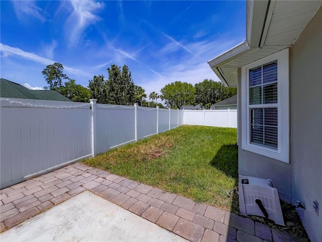 view of yard with a fenced backyard and a patio