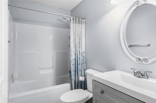 full bathroom with vanity, shower / bath combo with shower curtain, and toilet