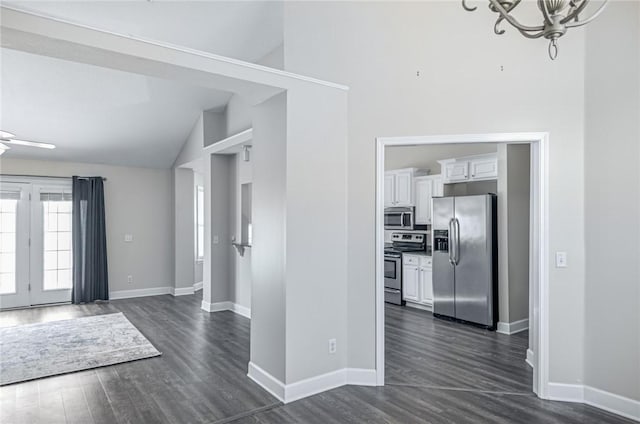 entryway featuring an inviting chandelier, baseboards, and dark wood-type flooring