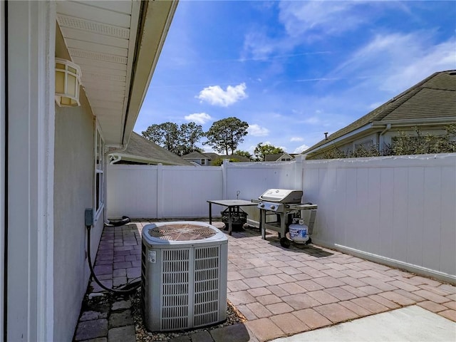 view of patio / terrace featuring area for grilling, cooling unit, and a fenced backyard