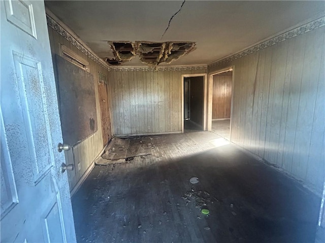 empty room featuring wood walls