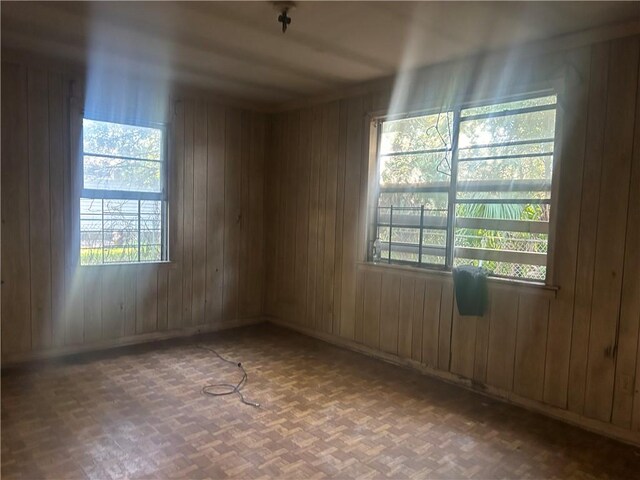 unfurnished room with wooden walls