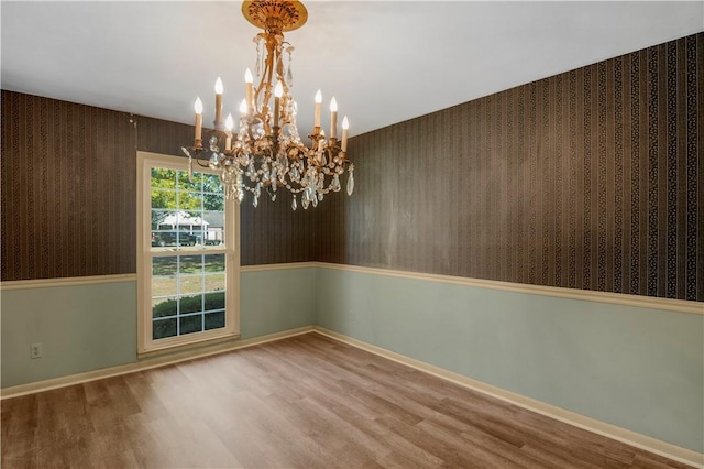208 Plantation Dr, Waycross, GA 31501 - unfurnished dining area featuring an inviting chandelier, baseboards, wood finished floors, and wallpapered walls