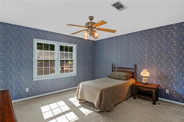 208 Plantation Dr, Waycross, GA 31501 - carpeted bedroom with a ceiling fan and visible vents