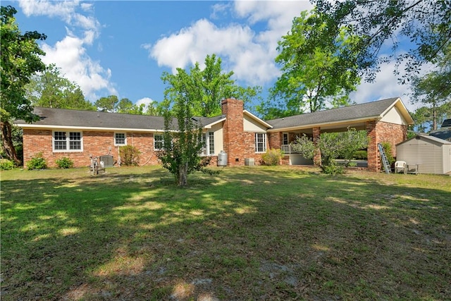 208 Plantation Dr, Waycross, GA 31501 - back of house featuring brick siding, a storage shed, an outbuilding, a chimney, and a yard