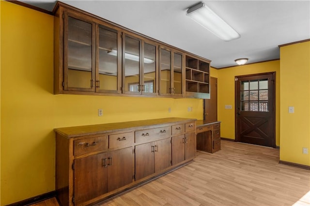 208 Plantation Dr, Waycross, GA 31501 - kitchen with crown molding, baseboards, light wood finished floors, and open shelves