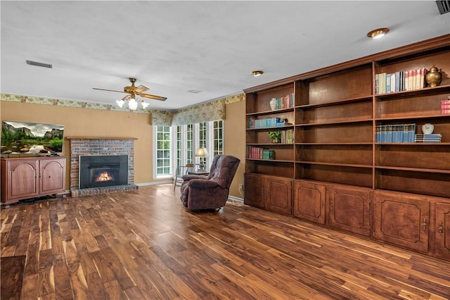 208 Plantation Dr, Waycross, GA 31501 - living area with a ceiling fan, visible vents, wood finished floors, and a fireplace