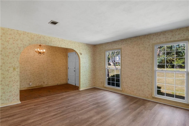 208 Plantation Dr, Waycross, GA 31501 - empty room with wallpapered walls and wood finished floors