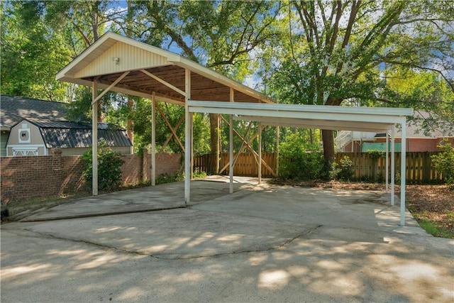 208 Plantation Dr, Waycross, GA 31501 - view of vehicle parking with a detached carport, fence, and driveway