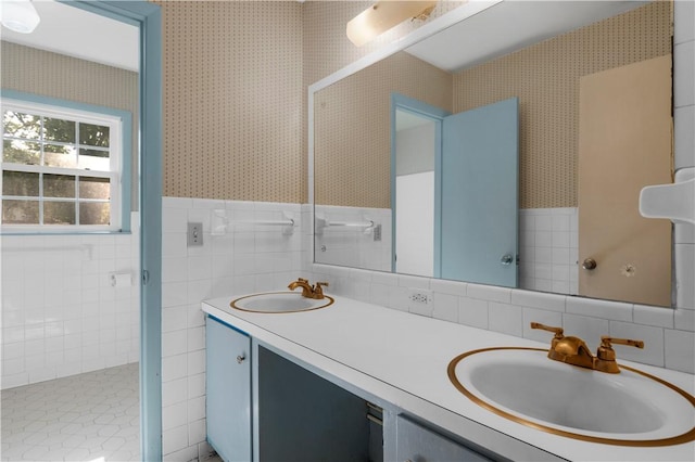 208 Plantation Dr, Waycross, GA 31501 - bathroom featuring a sink, tile walls, wallpapered walls, and double vanity