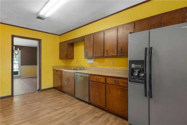 208 Plantation Dr, Waycross, GA 31501 - kitchen featuring light countertops, appliances with stainless steel finishes, a sink, and light wood-style floors