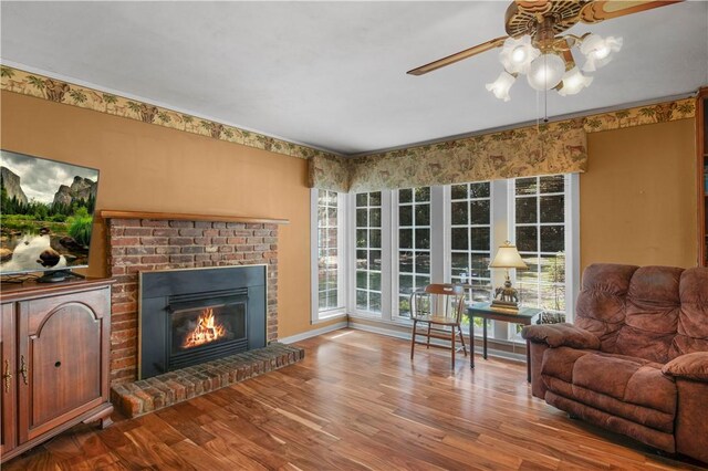208 Plantation Dr, Waycross, GA 31501 - living area with ceiling fan, a brick fireplace, and wood finished floors
