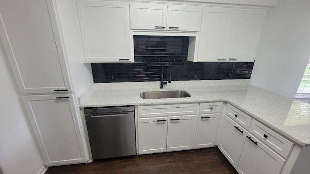 102 Norwood Ct, Brunswick, GA 31525 - kitchen featuring dishwasher, decorative backsplash, white cabinets, a peninsula, and dark wood finished floors
