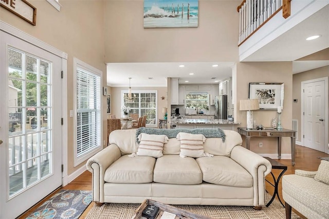 200 Colgana Way, Saint Simons Island, GA 31522 - living room featuring wood finished floors, a high ceiling, and recessed lighting
