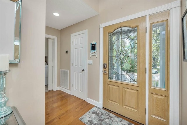 200 Colgana Way, Saint Simons Island, GA 31522 - foyer entrance with wood finished floors, healthy amount of natural light, and washer / clothes dryer