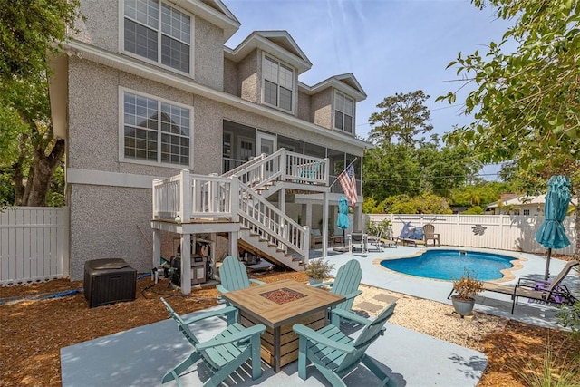 200 Colgana Way, Saint Simons Island, GA 31522 - view of pool featuring a fire pit, stairway, a sunroom, and a fenced backyard