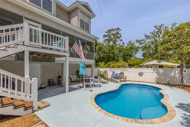 200 Colgana Way, Saint Simons Island, GA 31522 - view of swimming pool with a sunroom, a patio area, and a fenced backyard