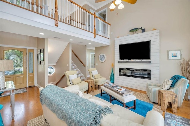 200 Colgana Way, Saint Simons Island, GA 31522 - living area featuring wood finished floors, ceiling fan, stairs, and a high ceiling