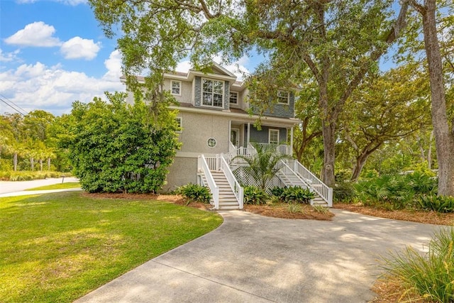 200 Colgana Way, Saint Simons Island, GA 31522 - view of front facade featuring stairs, a porch, a front lawn, and stucco siding