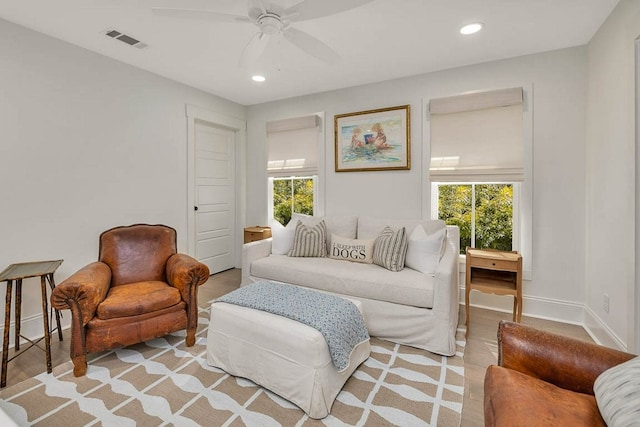 living room with ceiling fan and plenty of natural light