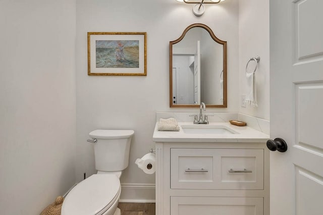 bathroom featuring vanity and toilet