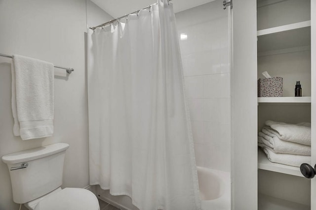 bathroom with shower / bathtub combination with curtain and toilet