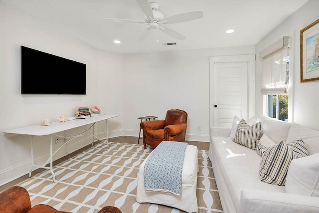 living room featuring light hardwood / wood-style flooring and ceiling fan