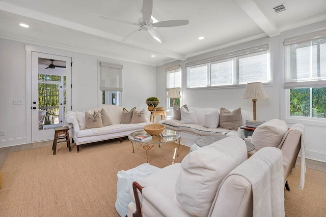 living room featuring beamed ceiling, ceiling fan, light hardwood / wood-style floors, and a wealth of natural light