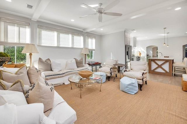 living room featuring ceiling fan, beam ceiling, and light hardwood / wood-style flooring