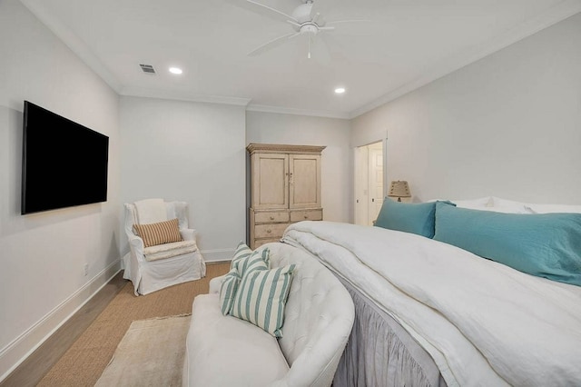 bedroom featuring ceiling fan, ornamental molding, and light hardwood / wood-style floors