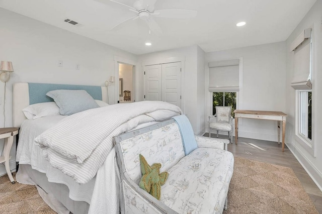 bedroom with ceiling fan, hardwood / wood-style floors, and a closet