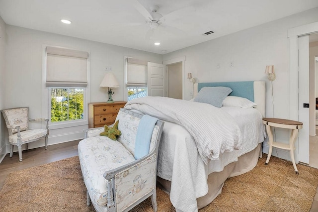 bedroom with hardwood / wood-style flooring and ceiling fan