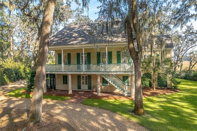 view of front of house featuring french doors and a front yard