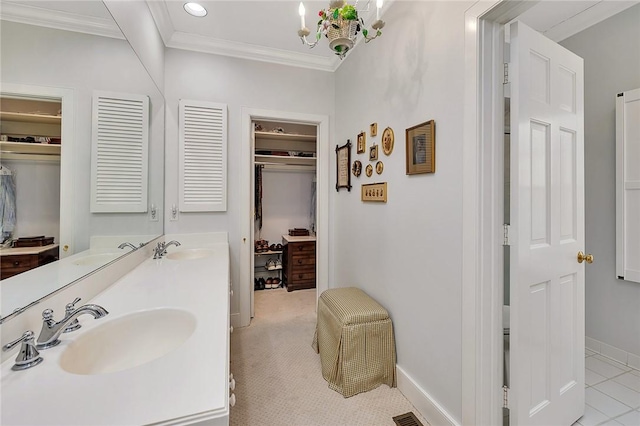 bathroom with tile patterned floors, ornamental molding, a chandelier, and vanity