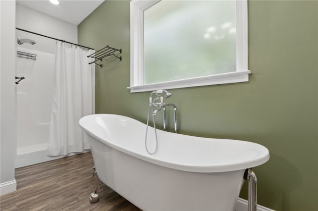 18 Ace Cir, Brunswick, GA 31523 - full bathroom with wood finished floors, a freestanding tub, healthy amount of natural light, and a shower with curtain