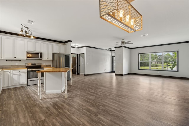 18 Ace Cir, Brunswick, GA 31523 - kitchen featuring wooden counters, stainless steel appliances, crown molding, white cabinets, and open floor plan
