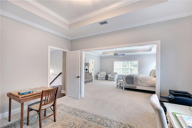 bedroom featuring carpet, crown molding, and a tray ceiling