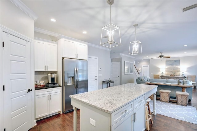 kitchen with pendant lighting, stainless steel fridge with ice dispenser, ceiling fan, tasteful backsplash, and white cabinetry