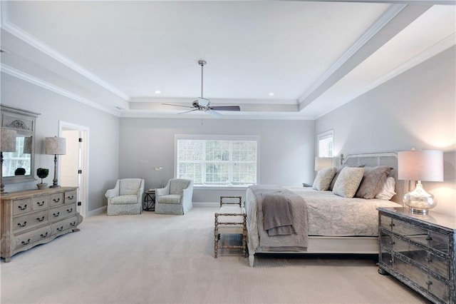 bedroom featuring a raised ceiling, ceiling fan, crown molding, and light colored carpet