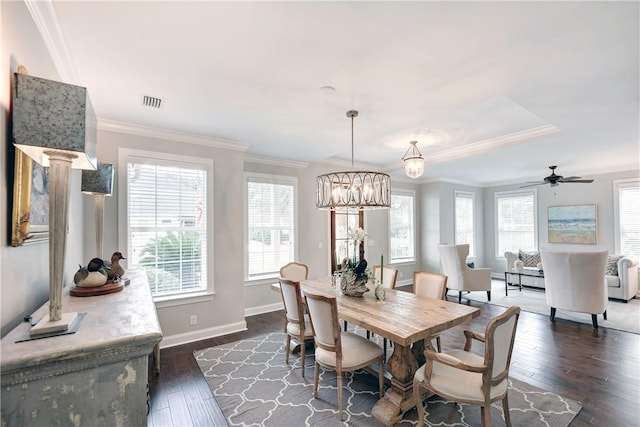 dining room featuring crown molding, ceiling fan with notable chandelier, and dark hardwood / wood-style floors