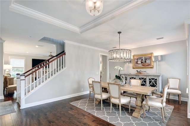 dining area featuring crown molding, ceiling fan with notable chandelier, and dark hardwood / wood-style floors