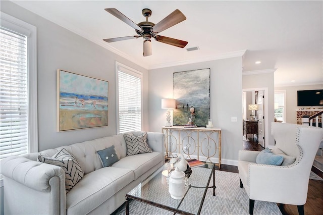 living room with crown molding, ceiling fan, and wood-type flooring