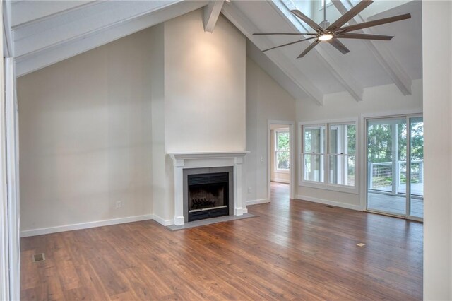 2593 Julienton Dr NE, Townsend, GA 31331 - unfurnished living room featuring a ceiling fan, high vaulted ceiling, beamed ceiling, a fireplace with flush hearth, and baseboards