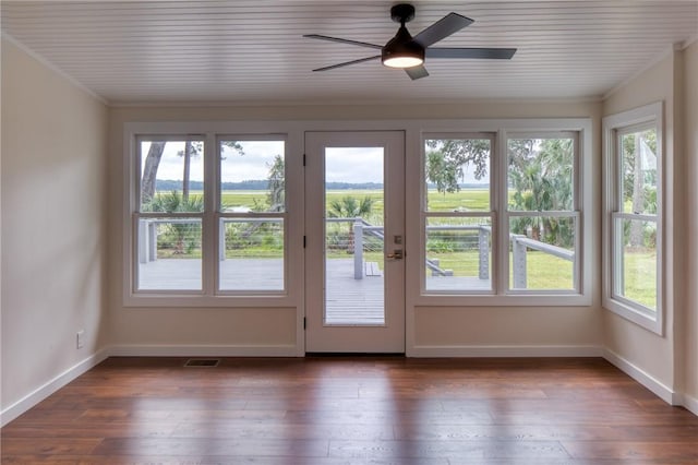 doorway to outside featuring a wealth of natural light, dark hardwood / wood-style flooring, and crown molding